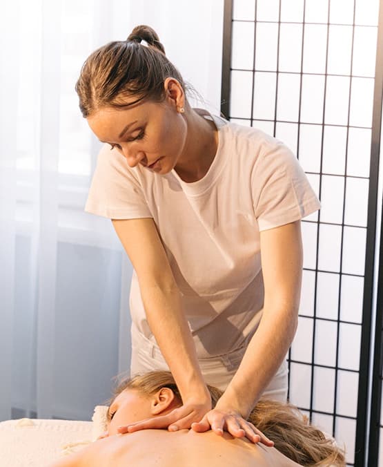 Professional massage room in London with treatment table, candles, and aromatherapy oils